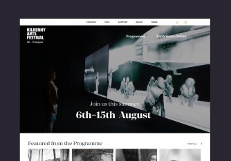 Desktop homepage with full width and height photo and festival dates in the centre.